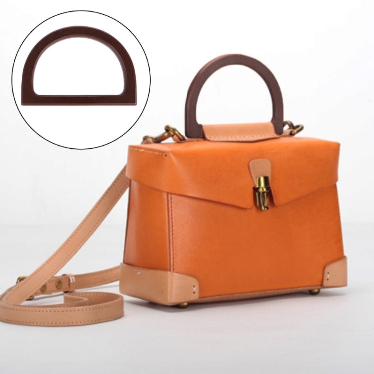 D-shaped dark brown wooden handbag handle on orange bag, metal clasp