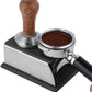 Espresso tamper stand with stainless base and brown wooden handle tamping tool
