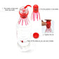 Red jellyfish toy with long tentacles beside a clear bottle setup.
