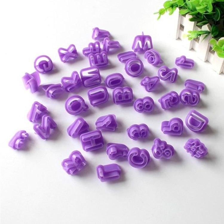 Purple plastic alphanumeric cookie molds scattered, letter and number shapes