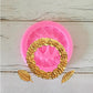 Pink silicone mold with raised rose garland ring and leaf motifs