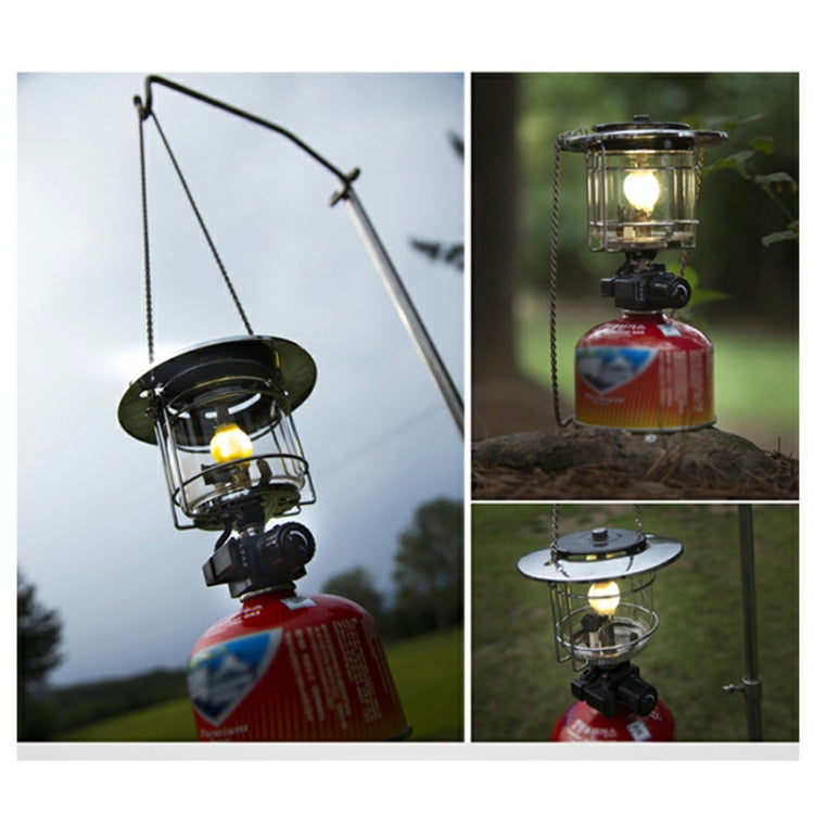 Camping gas lantern with fitted lamp top and glowing flame