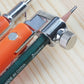 Stainless metal clamp and orange housing on a circle drawing compass