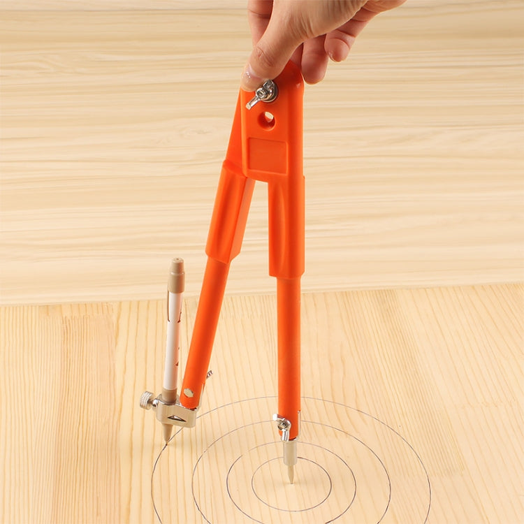 Hand holding orange circle compass for drawing circles on wood