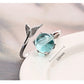 Silver open ring with turquoise oval gemstone, fish-tail design, and size marker text