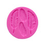 Pink silicone mold with embossed feather design of multiple leaf-shaped feathers
