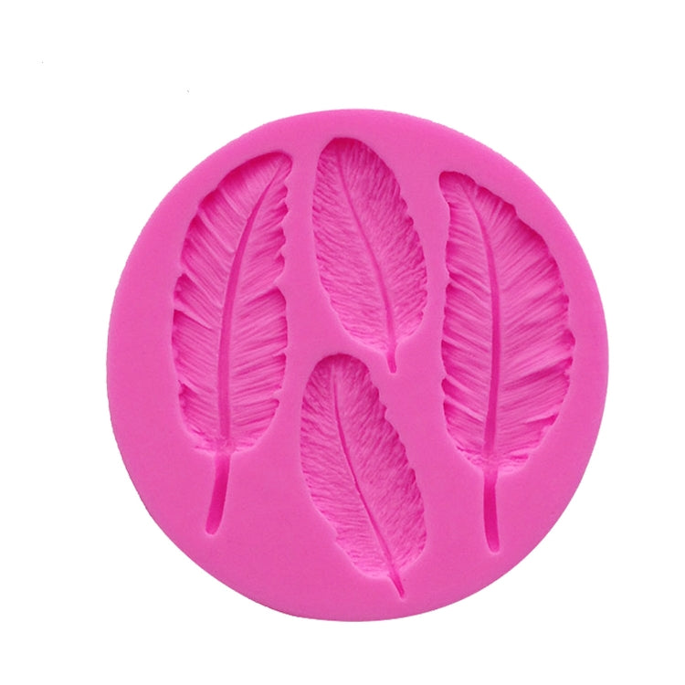 Pink silicone mold with embossed feather design of multiple leaf-shaped feathers