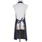Navy denim halter apron back view with crossed straps and tied waist.