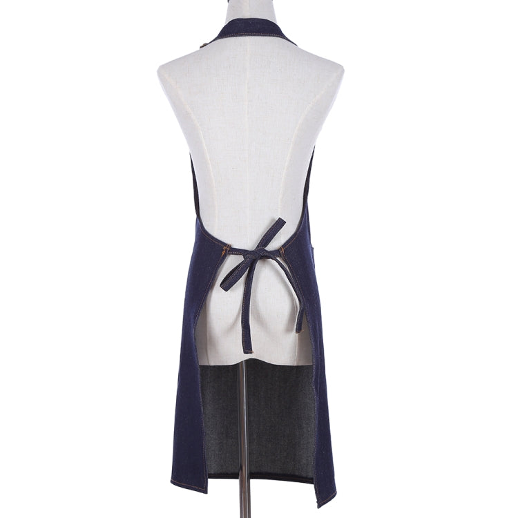 Navy denim halter apron back view with crossed straps and tied waist.