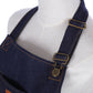 Navy denim apron straps with metal buckles and small logo charm detail.
