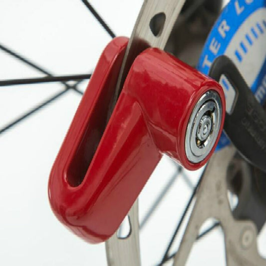 Red disk brake rotor lock with keyed cylinder on scooter wheel