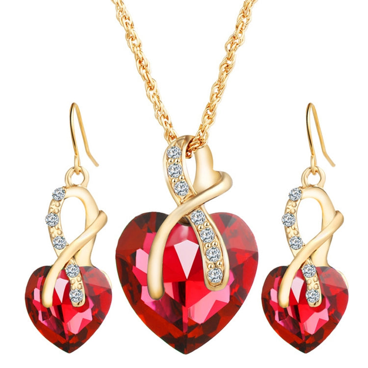 Gold-tone heart jewelry set with red heart pendant necklace and matching drop earrings