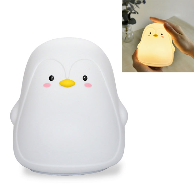 White penguin-shaped silicone night light with cute face design.