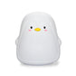 White penguin-shaped silicone night light, front view with smiling face.