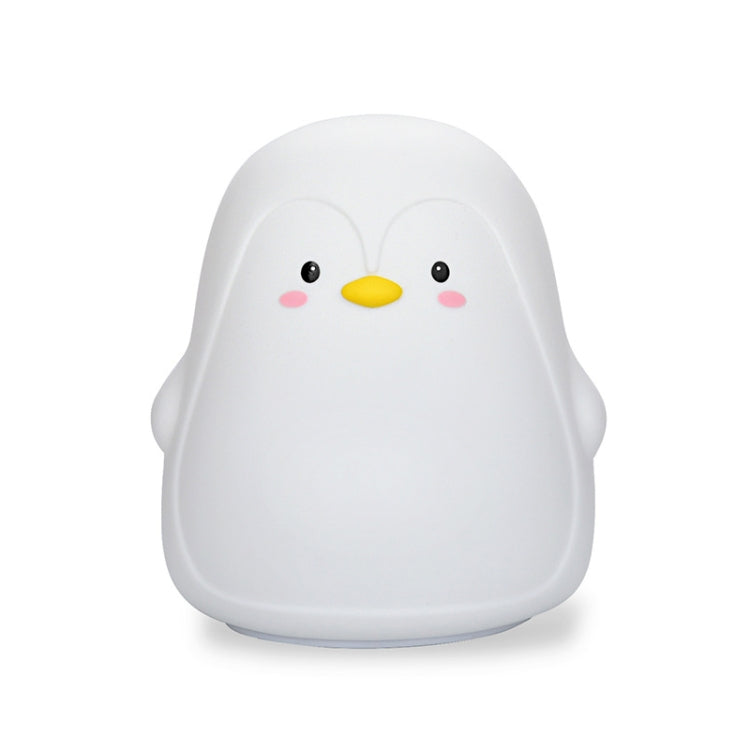 White penguin-shaped silicone night light, front view with smiling face.