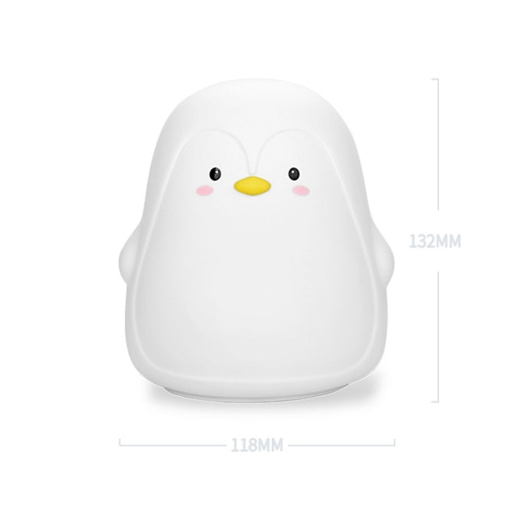 White penguin-shaped silicone night light on plain background with size markings.