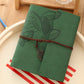 Green PU leather vintage photo album with embossed leaves, twine tie, and hanging charm.