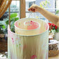 Pink floral laundry cover on white spiral drying rack with inner ring