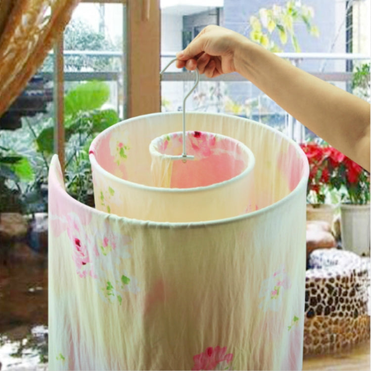 Pink floral laundry cover on white spiral drying rack with inner ring