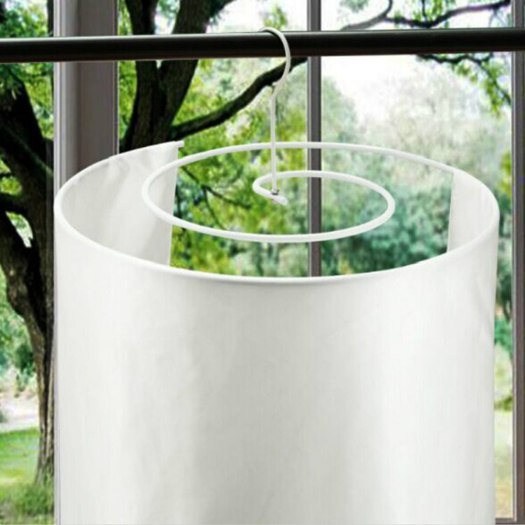 White spiral drying rack with hanging loop inside a round laundry bag