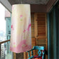Cream floral laundry cover hanging from a white round spiral drying rack