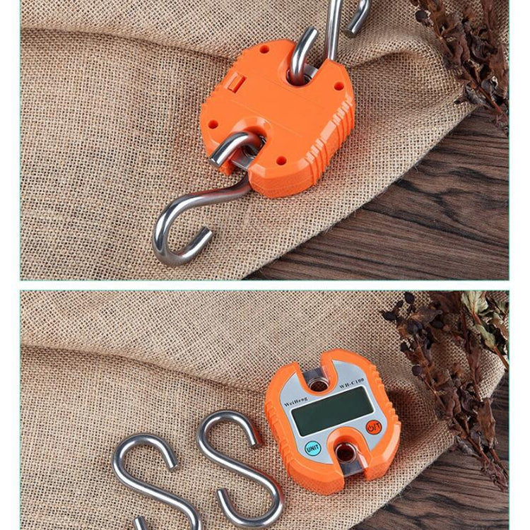Orange mini digital hook scale with two metal hooks on a flat surface