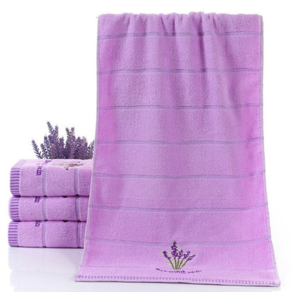 Lavender cotton face towel with horizontal stripes and embroidered flower at corner