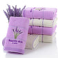 Stack of lavender cotton face towels with embroidered flower sprig and ribbed border