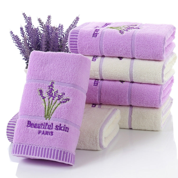 Stack of lavender cotton face towels with embroidered flower sprig and ribbed border