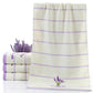 White cotton face towel with lavender horizontal stripes and embroidered sprig at bottom