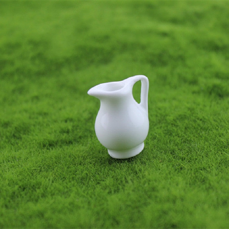 Mini white ceramic vase with side cutout handle and flared top
