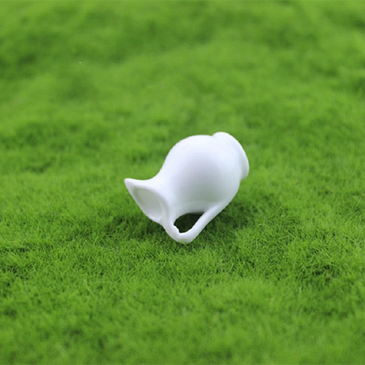 Mini white ceramic vase with curved spout and flared base, angled view