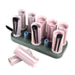 Heated hair curling rollers on gray base with pink tubes, black clamps, and blue tips
