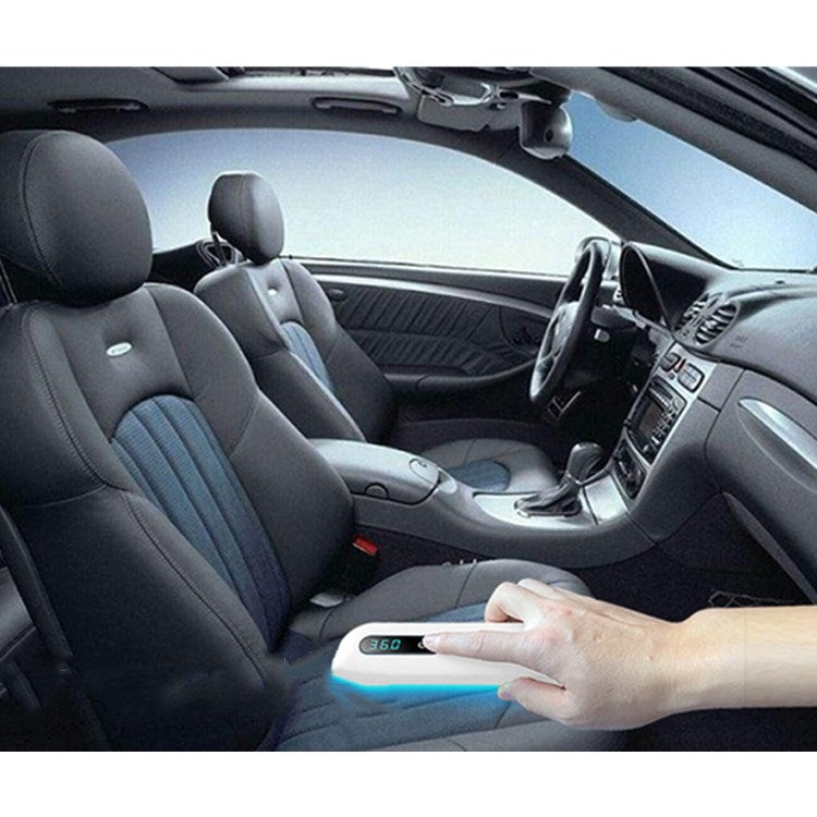Handheld UV sterilizer wand with blue light near car seats