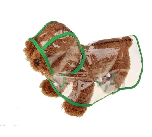 Pet dog transparent raincoat with green trim and hood, worn on brown fur