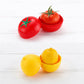 Fruit and vegetable storage containers with red and yellow lids on a white surface