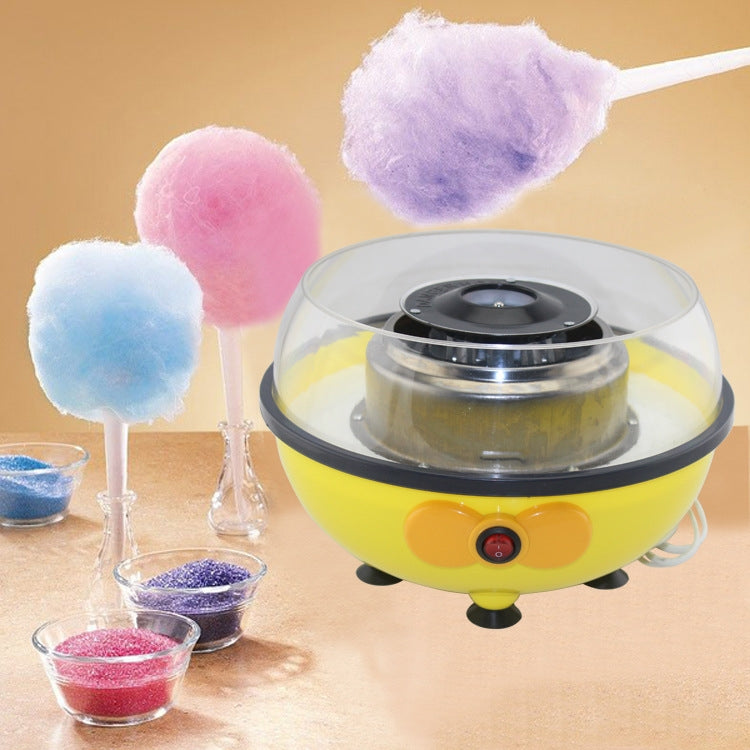 Mini electric cotton candy machine with colorful cotton candy on sticks and bowls
