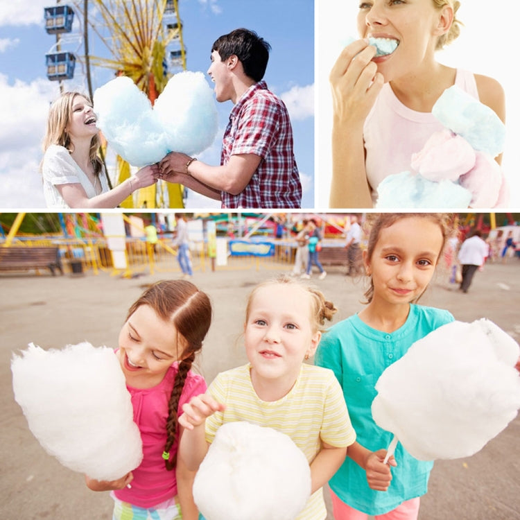 Family enjoying large cotton candy at an outdoor fair