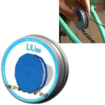 Blue felt roller chain oiler in metal tin, held by hand