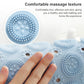 Light blue round massage foot mat close-up with raised suction bumps texture