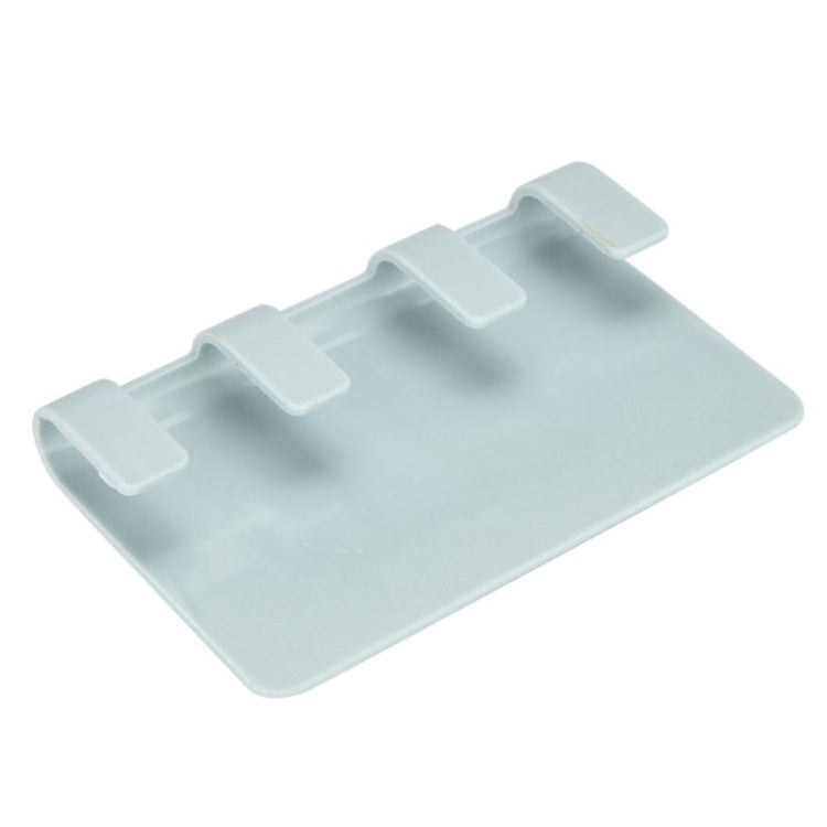 Light blue adhesive phone charging holder with raised slots and cable channel