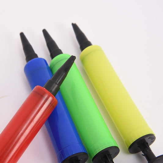 Close-up of mini hand held balloon inflator pumps with colored cylinders and black tips