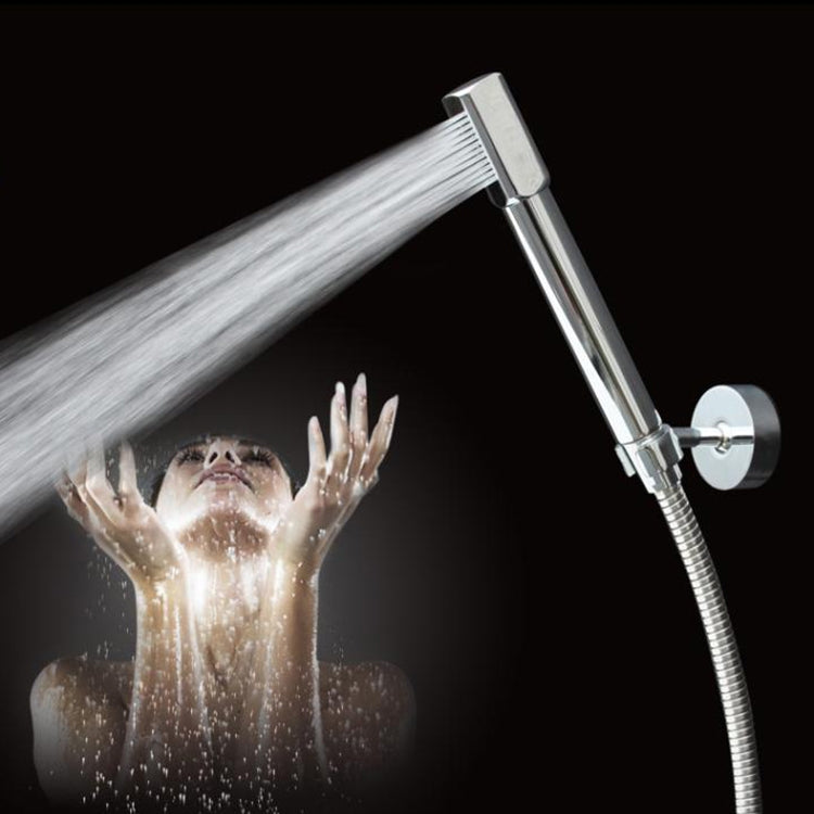Handheld round chrome shower head with flexible hose, spraying water
