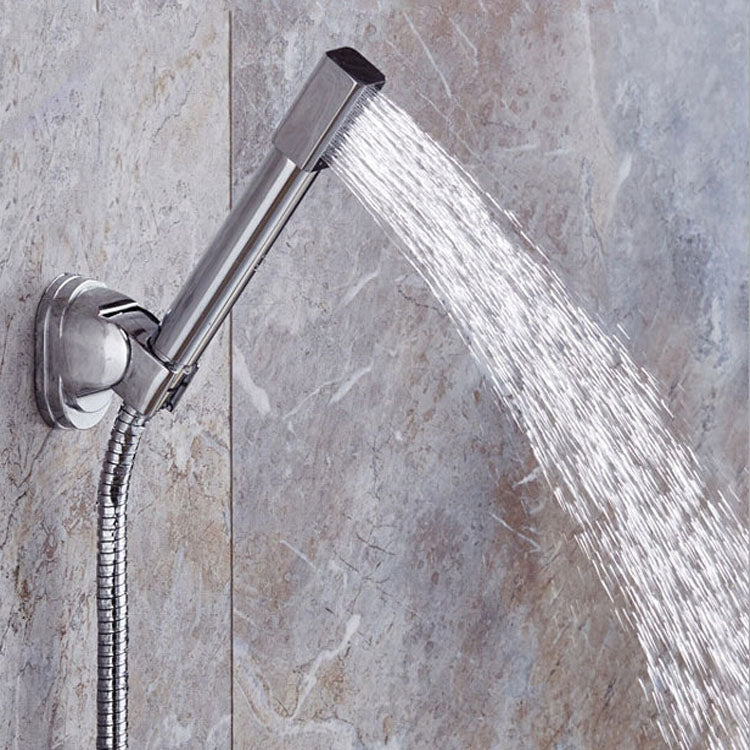 Installed round chrome handheld shower with flexible hose spraying water