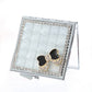 Open mini compact mirror with silver rhinestone frame, light mirror panel, and bow charm