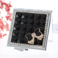Mini folding cosmetic mirror with silver rhinestone border, dark mirror, and gem bow charm
