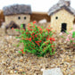 Artificial handmade model flower bush with red blossoms and green foliage