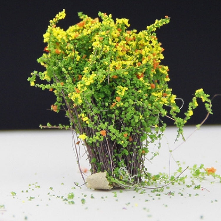 Artificial handmade model flower bush with yellow blossoms and green foliage
