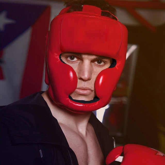 Red adjustable adult boxing training helmet worn by boxer with padded face guard
