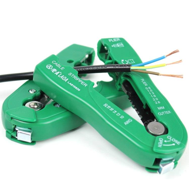 Green manual wire stripper tool with open jaws holding multi-core cable